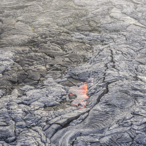 Molten lava glowing near dried lava Molten lava glowing near dried lava