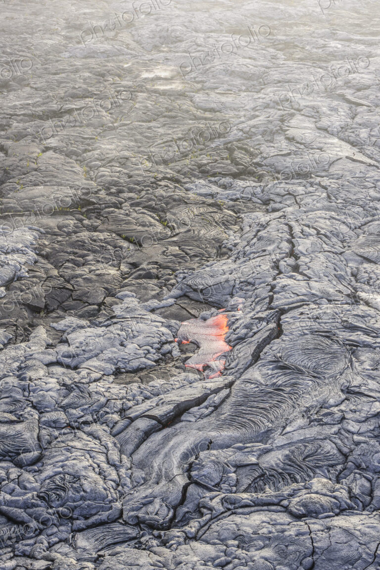 Molten lava glowing near dried lava