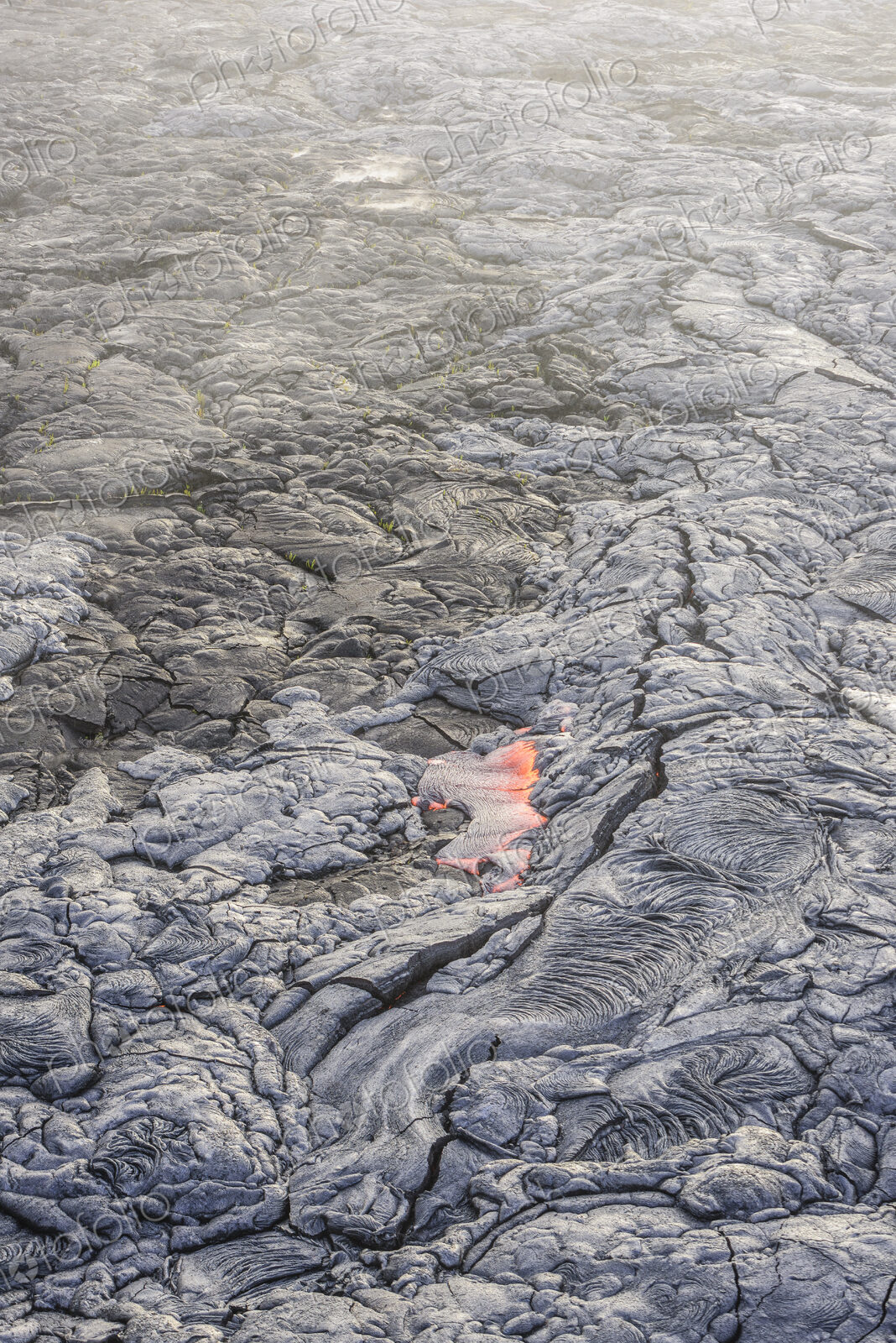 Molten lava glowing near dried lava