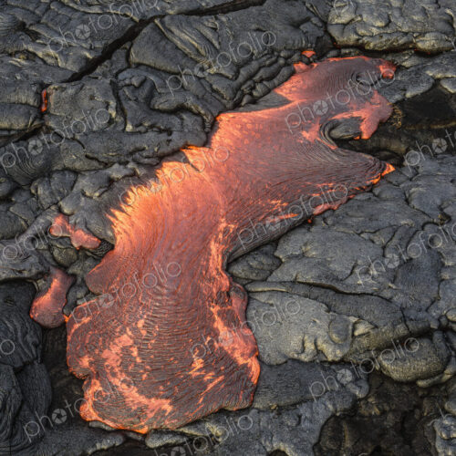 Molten lava glowing near dried lava Molten lava glowing near dried lava