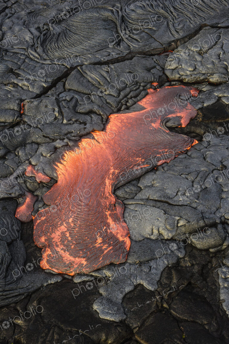 Molten lava glowing near dried lava