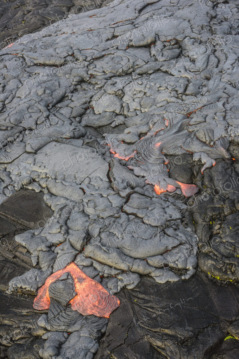 Molten lava glowing near dried lava