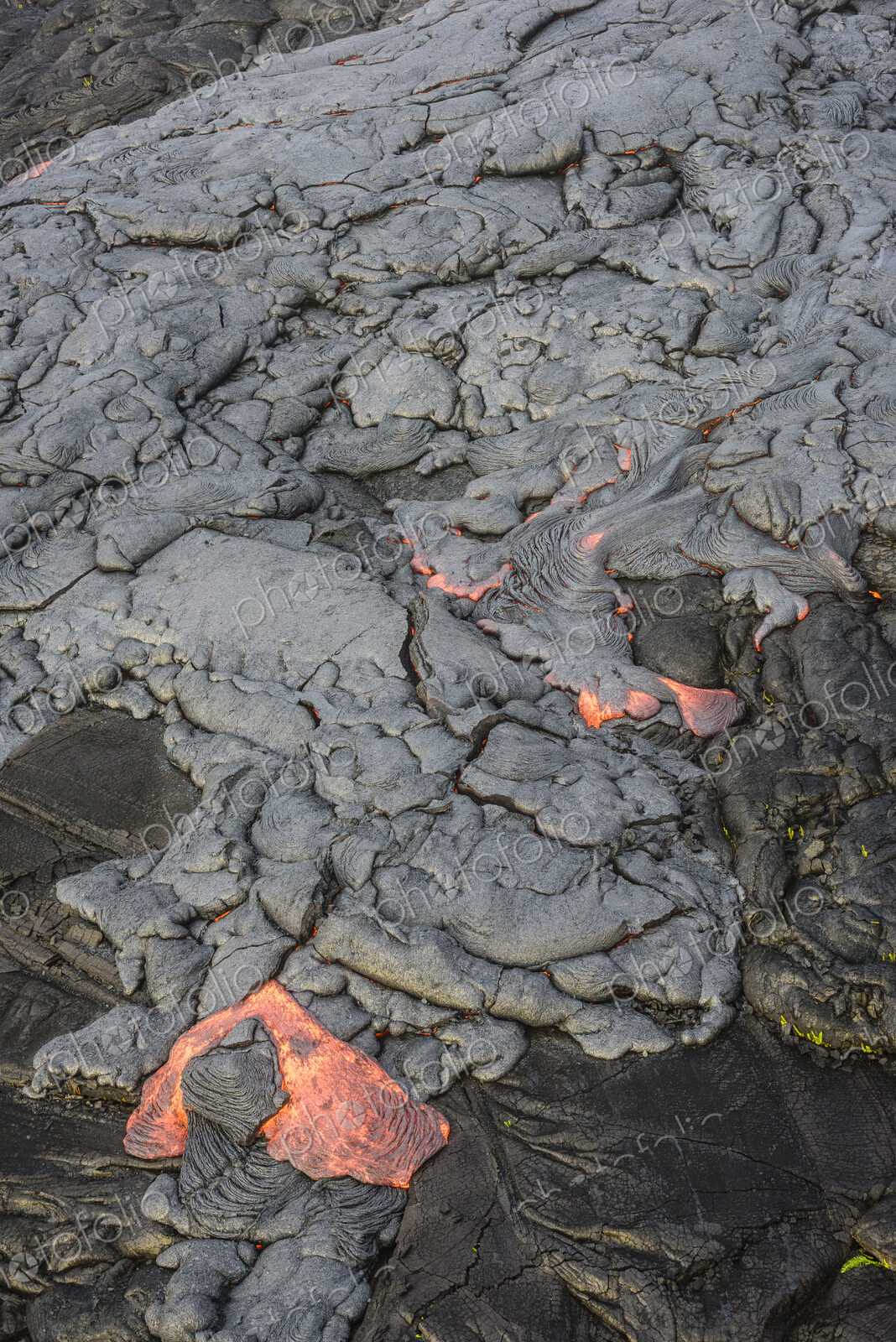 Molten lava glowing near dried lava