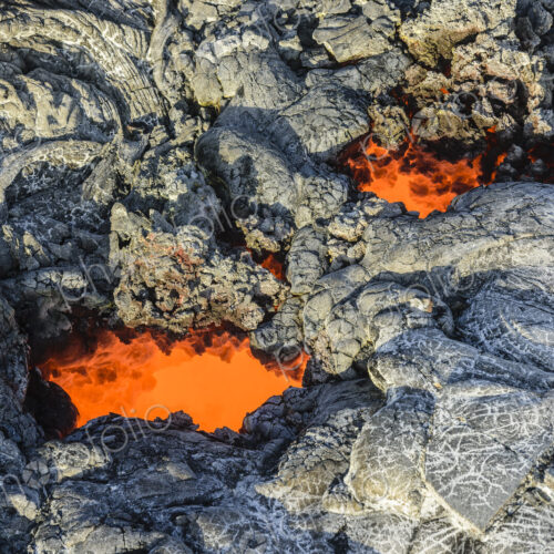 Molten lava glowing near dried lava Molten lava glowing near dried lava
