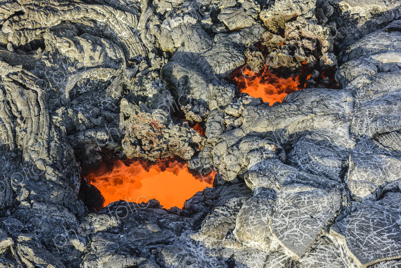 Molten lava glowing near dried lava