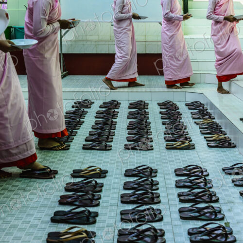 Monks leaving sandals near staircase