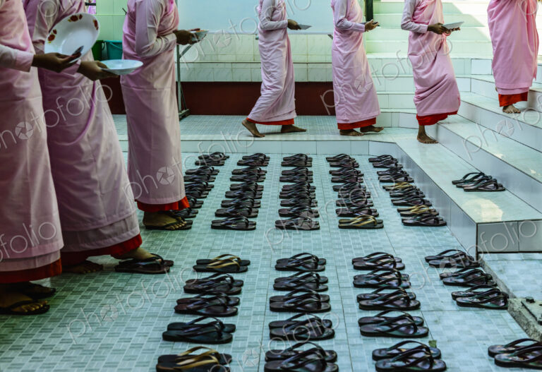 Monks leaving sandals near staircase
