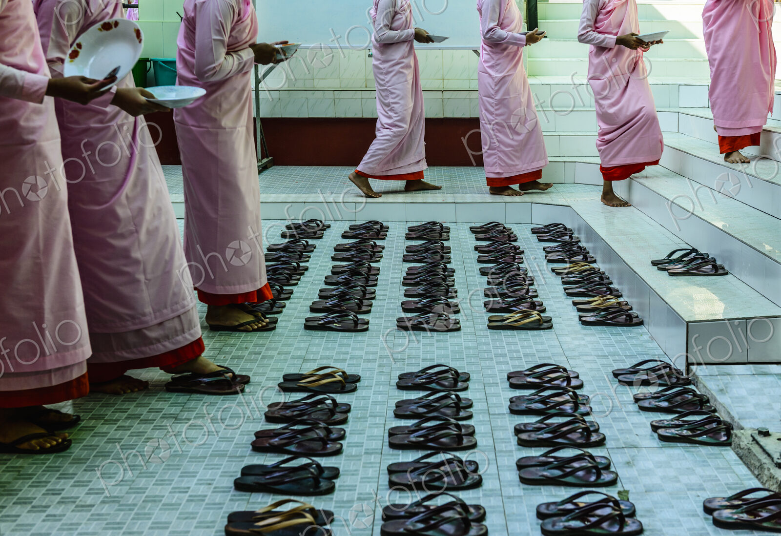 Monks leaving sandals near staircase