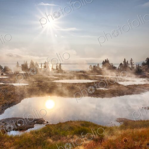 Morning sun glows over steaming geyser pools in Yellowstone's West Thumb Geyser Basin,… Morning sun glows over steaming geyser pools in Yellowstone's West Thumb Geyser Basin,…