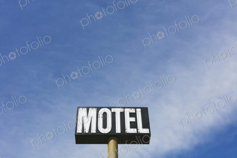 Motel sign against blue sky, near Maple Creek, Saskatchewan, Canada.