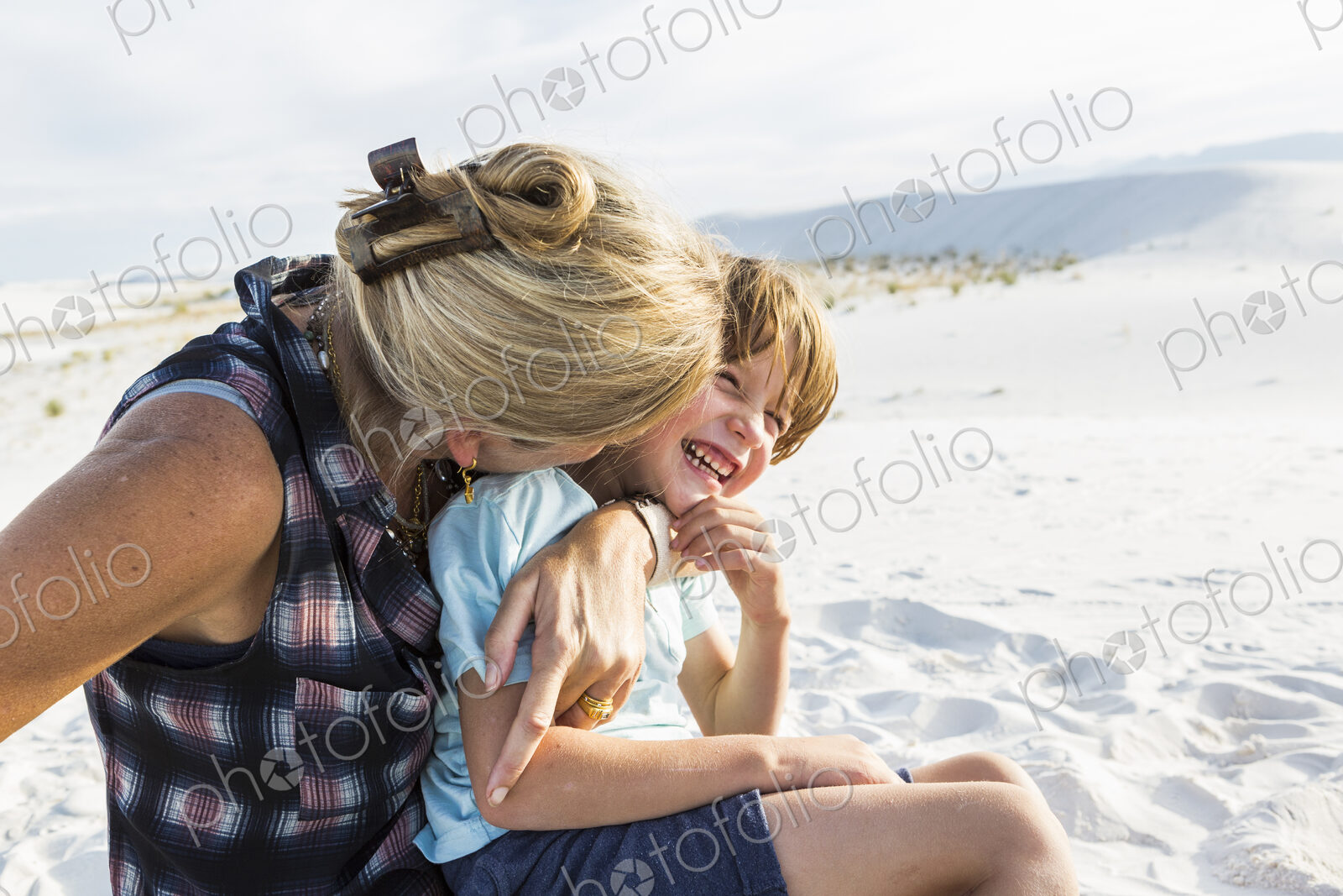Mother and her 6 year old son embracing, White Sands Nat’l Monument, NM