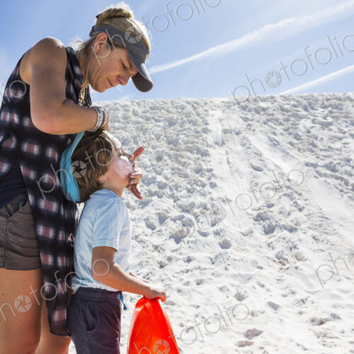 Mother appying sunblock to her child Mother appying sunblock to her child