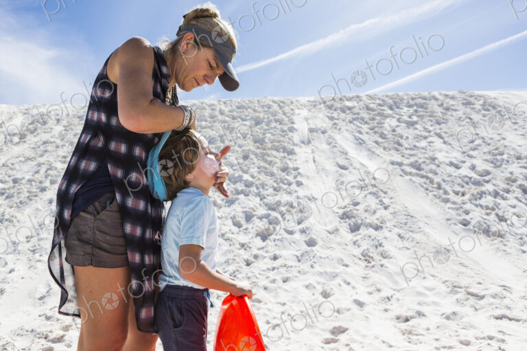 Mother appying sunblock to her child