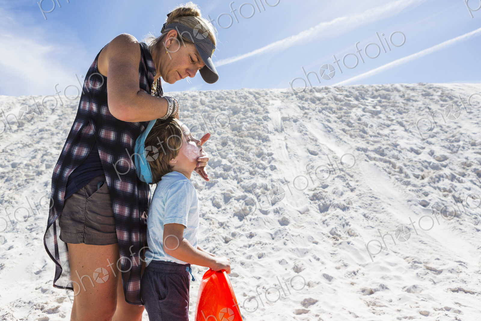 Mother appying sunblock to her child