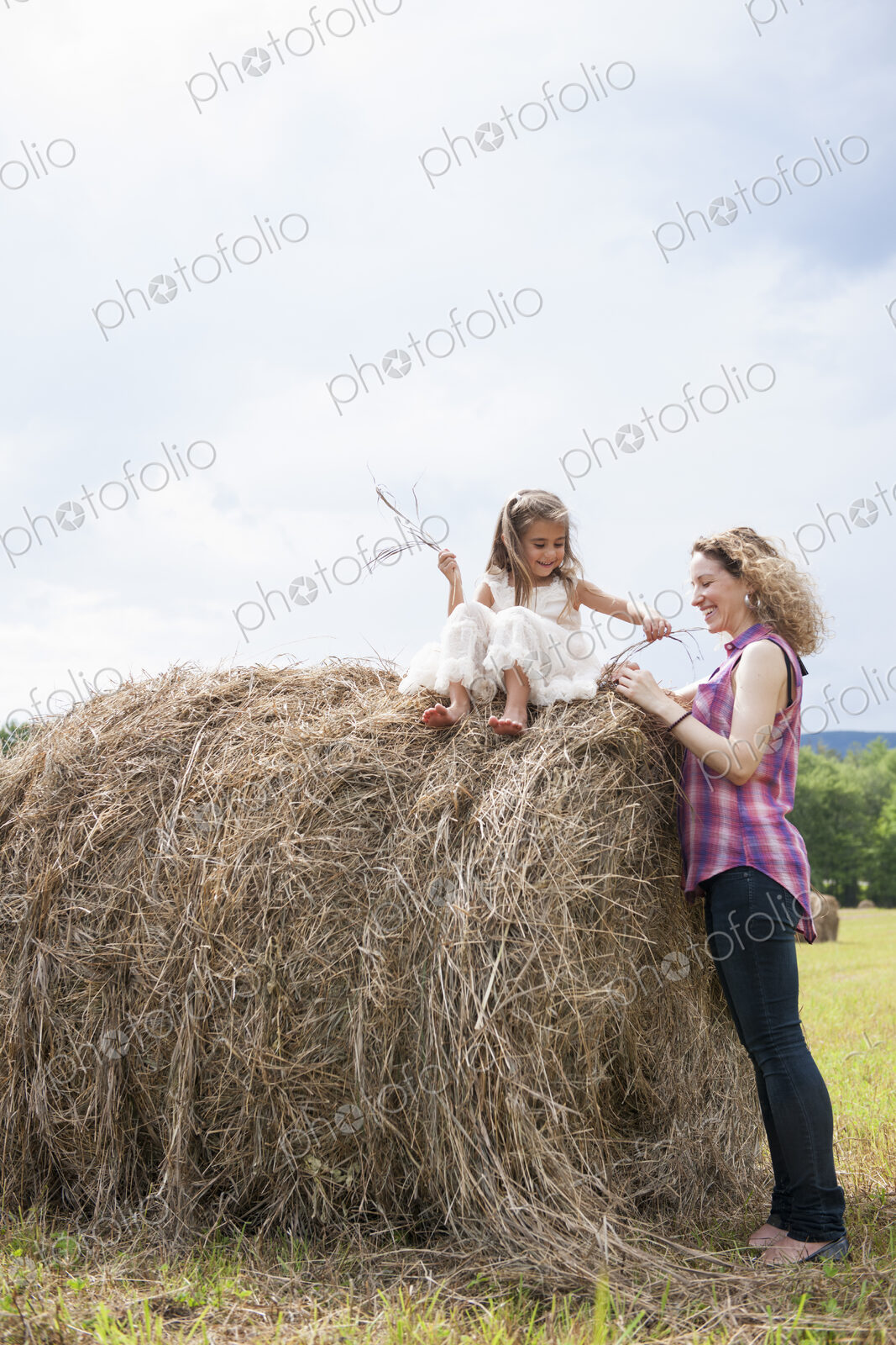 Mother playing outdoors with her daughter.