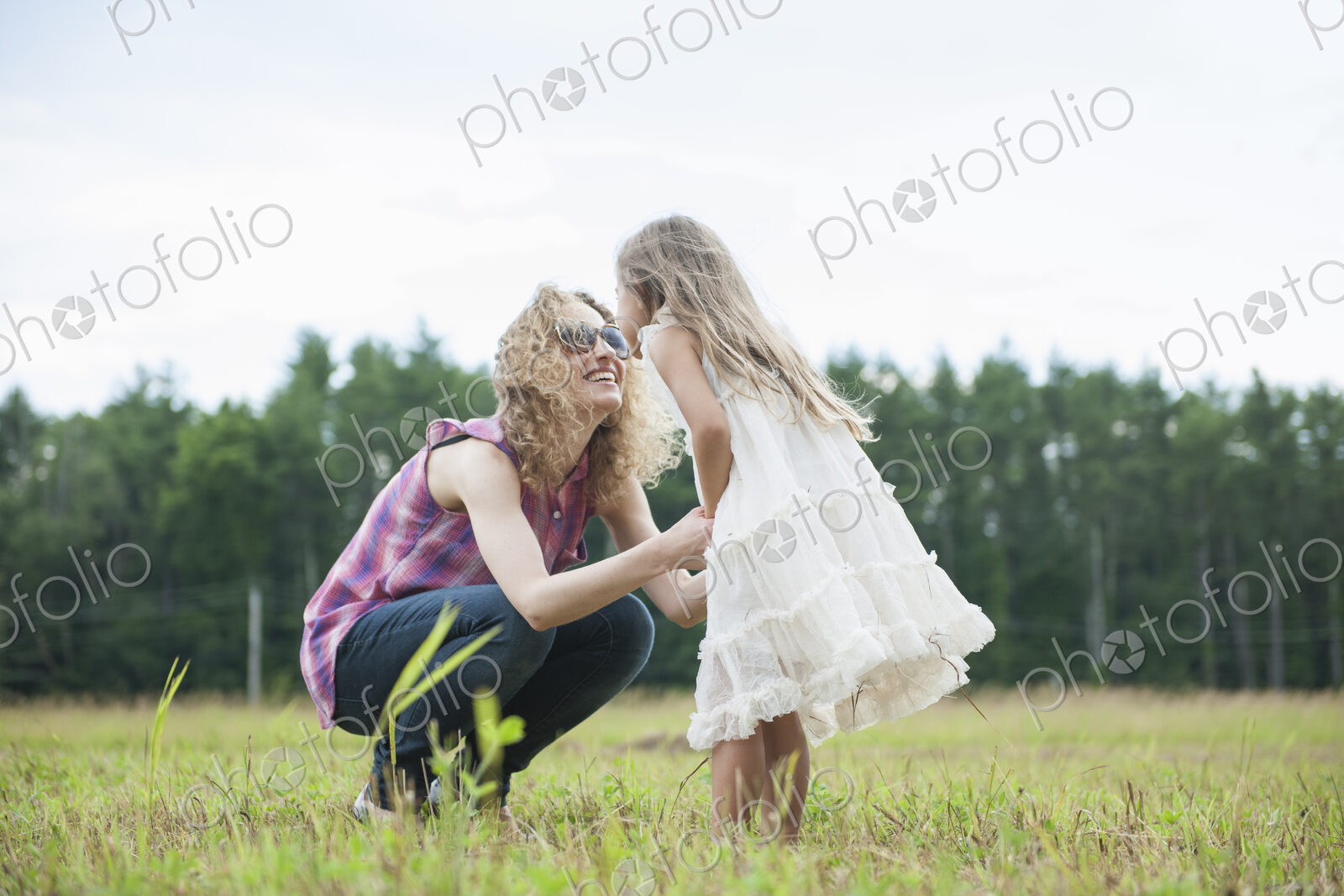 Mother playing outdoors with her daughter.