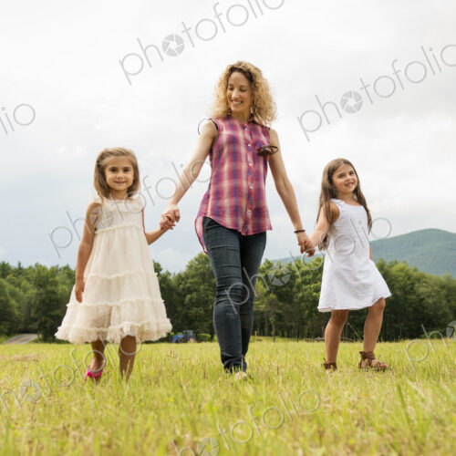 Mother playing outdoors with her daughters. Mother playing outdoors with her daughters.