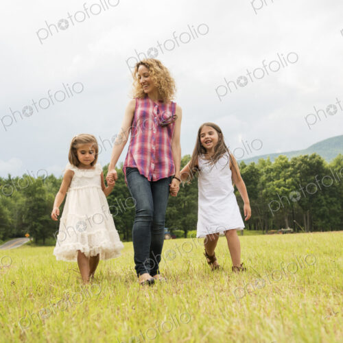 Mother playing outdoors with her daughters. Mother playing outdoors with her daughters.