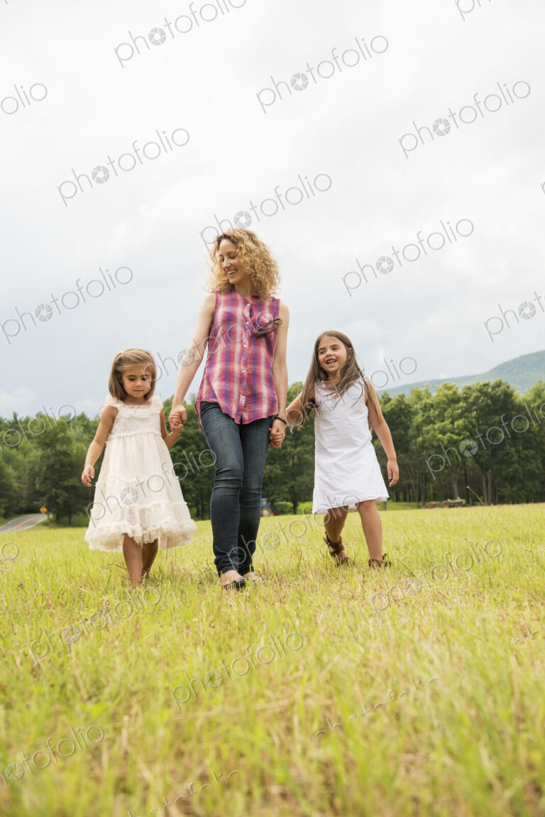 Mother playing outdoors with her daughters.