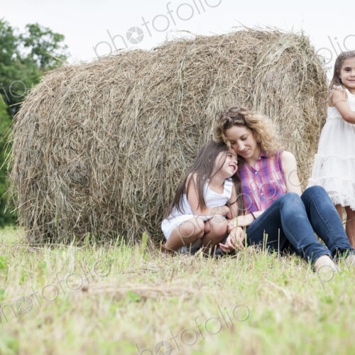 Mother playing outdoors with her daughters. Mother playing outdoors with her daughters.