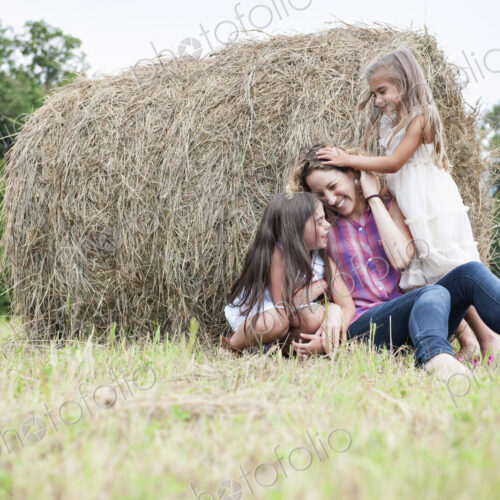 Mother playing outdoors with her daughters. Mother playing outdoors with her daughters.