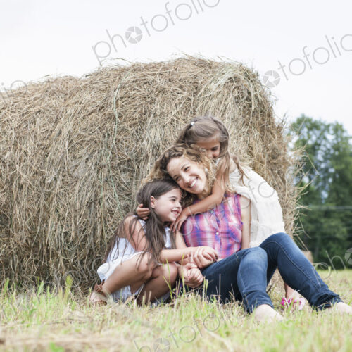 Mother playing outdoors with her daughters. Mother playing outdoors with her daughters.