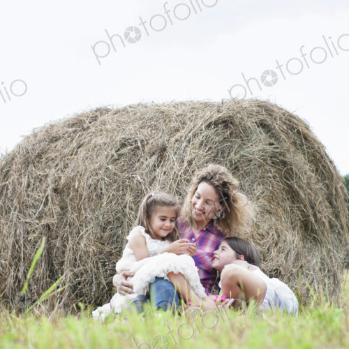 Mother playing outdoors with her daughters. Mother playing outdoors with her daughters.