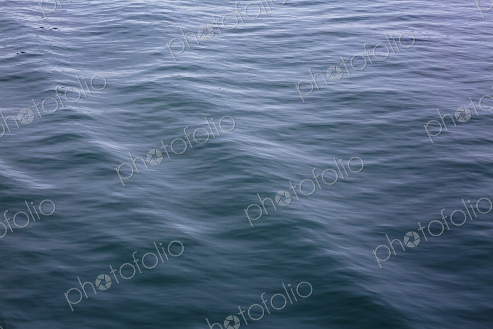 Motion blurred ocean waves, ripples in the surface.