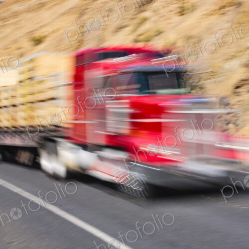 Motion blurred semi-truck on two lane rural highway, Wa USA