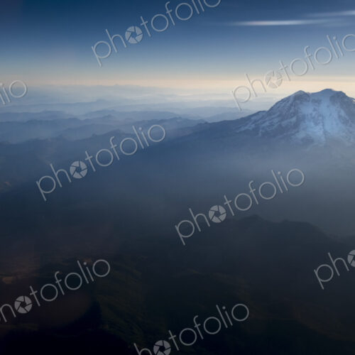 Mount Rainier National Park, an aerial view over the peak of Mount Rainier in the… Mount Rainier National Park, an aerial view over the peak of Mount Rainier in the…