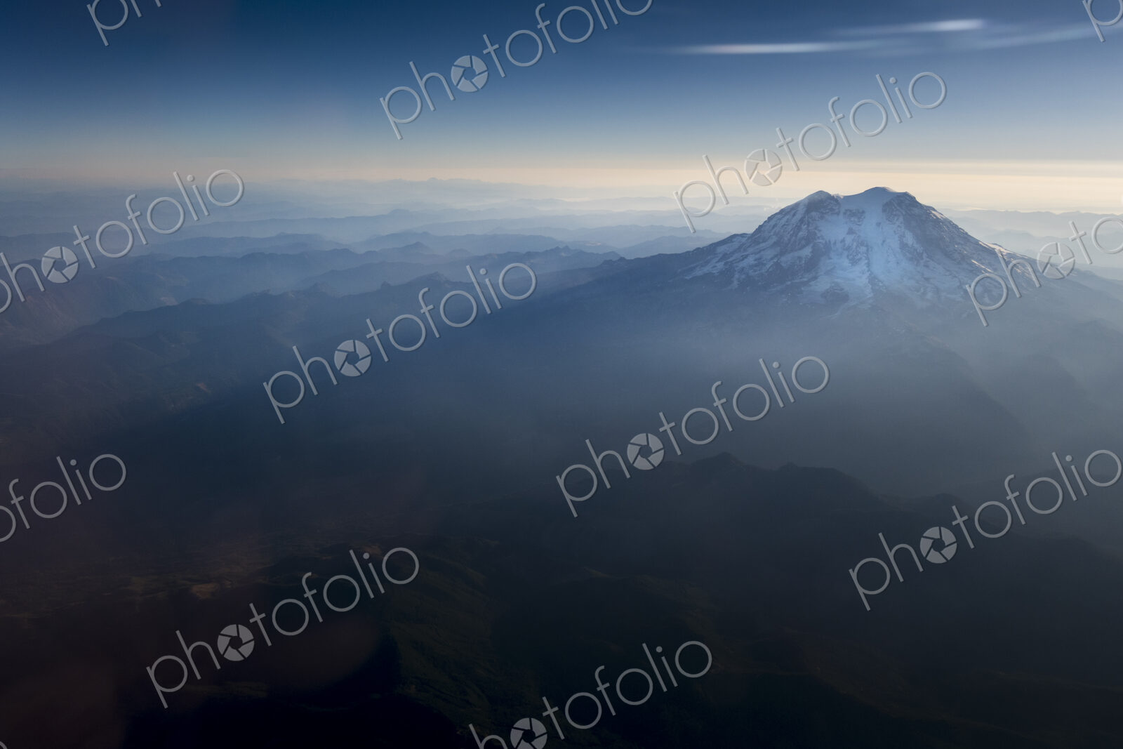 Mount Rainier National Park, an aerial view over the peak of Mount Rainier in the…