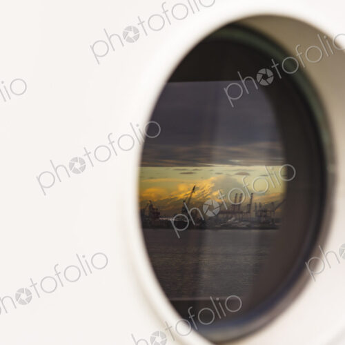 Mount Rainier and Seattle's harbor island viewed from a porthole Mount Rainier and Seattle's harbor island viewed from a porthole