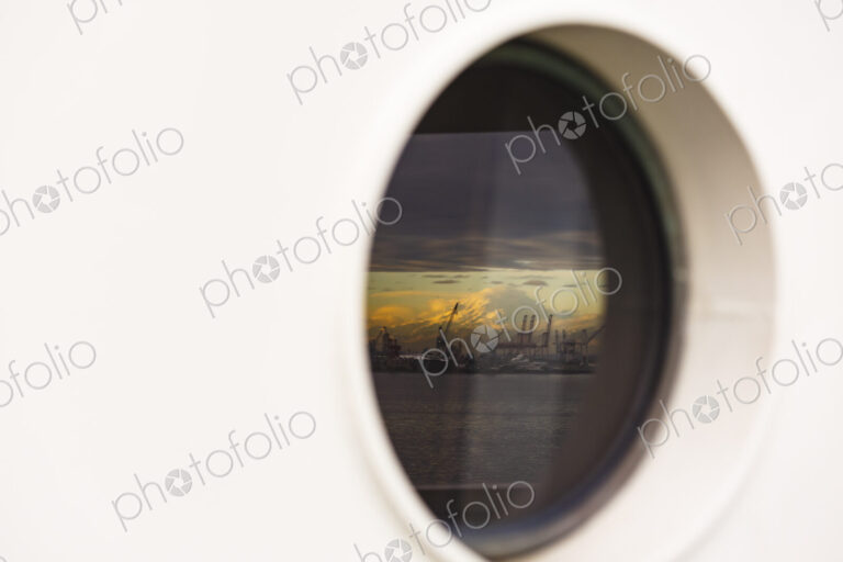 Mount Rainier and Seattle's harbor island viewed from a porthole