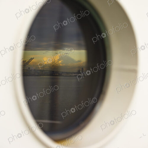 Mount Rainier and Seattle's harbor island viewed from a porthole on the Bainbridge… Mount Rainier and Seattle's harbor island viewed from a porthole on the Bainbridge…