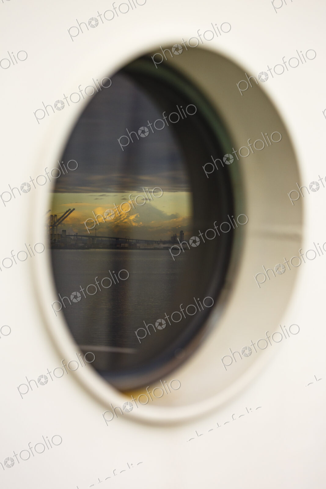 Mount Rainier and Seattle’s harbor island viewed from a porthole on the Bainbridge…