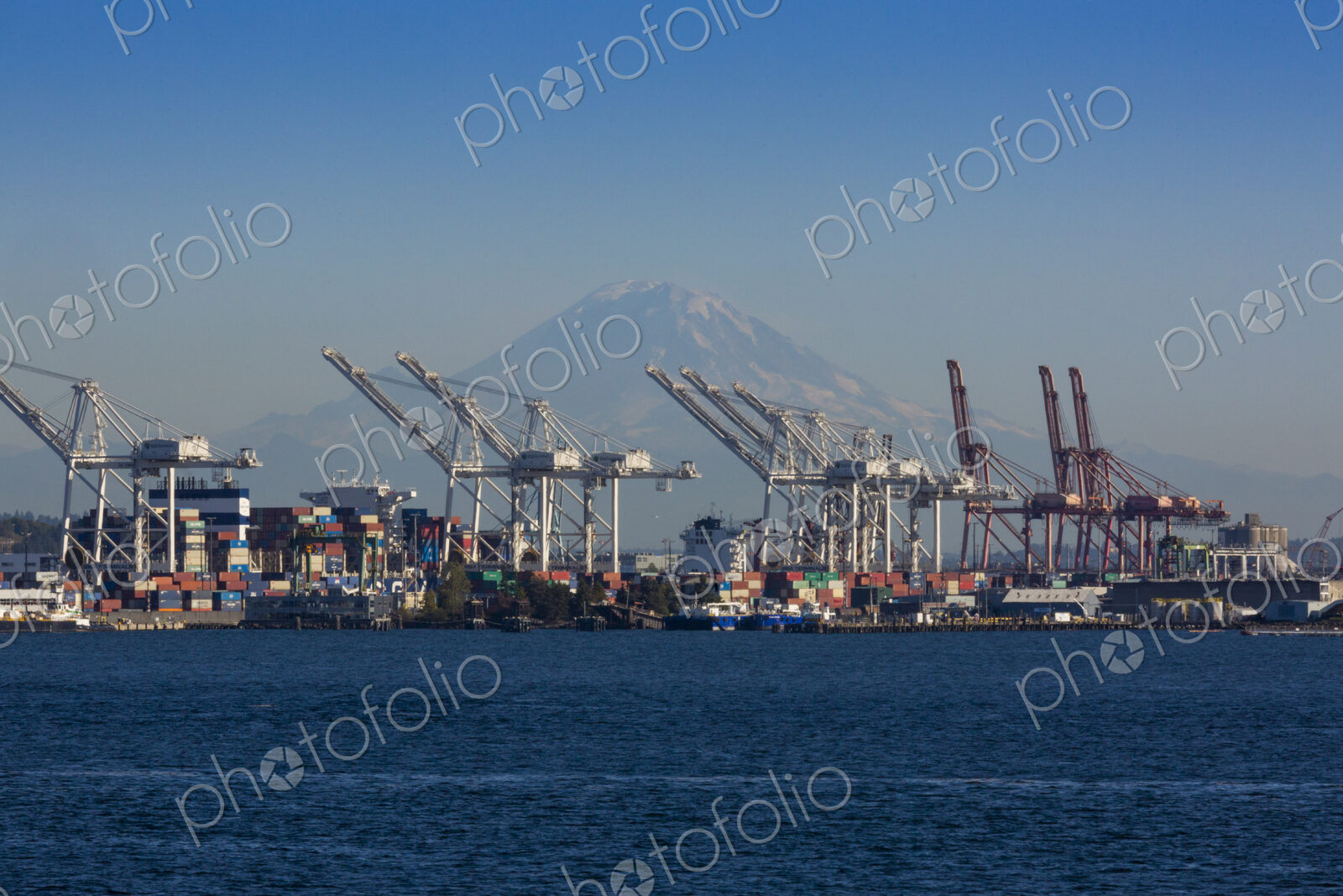 Mount Rainier seen through shipping cranes on the Seattle waterfront