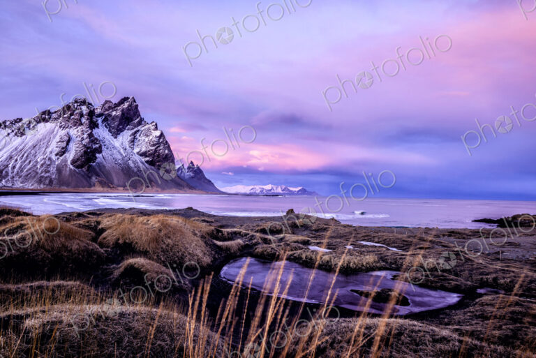 Mountains over beach and remote fields