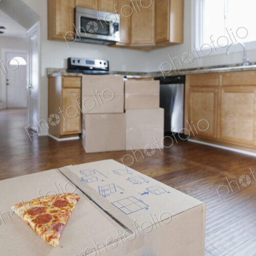 Moving house, relocation, cardboard boxes piled up in a house fitted kitchen, a slice… Moving house, relocation, cardboard boxes piled up in a house fitted kitchen, a slice…