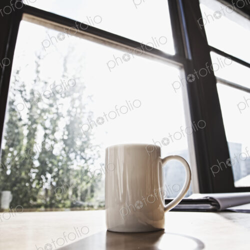 Mug on desk in urban office.