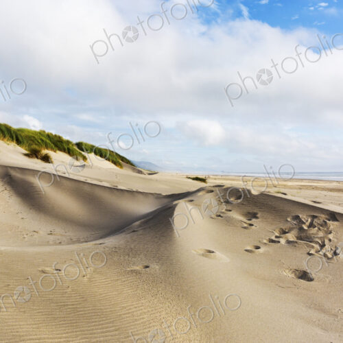 Nehalem Beach, sand dunes and footprints leading up a slope Nehalem Beach, sand dunes and footprints leading up a slope