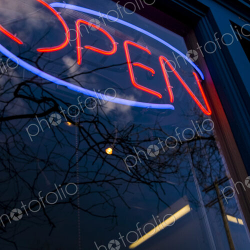 Neon Open sign in window of business and reflections in the glass, Seattle, WA, USA Neon Open sign in window of business and reflections in the glass, Seattle, WA, USA