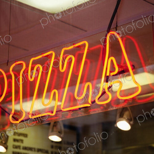 Neon Pizza Sign on Window at Night Neon Pizza Sign on Window at Night