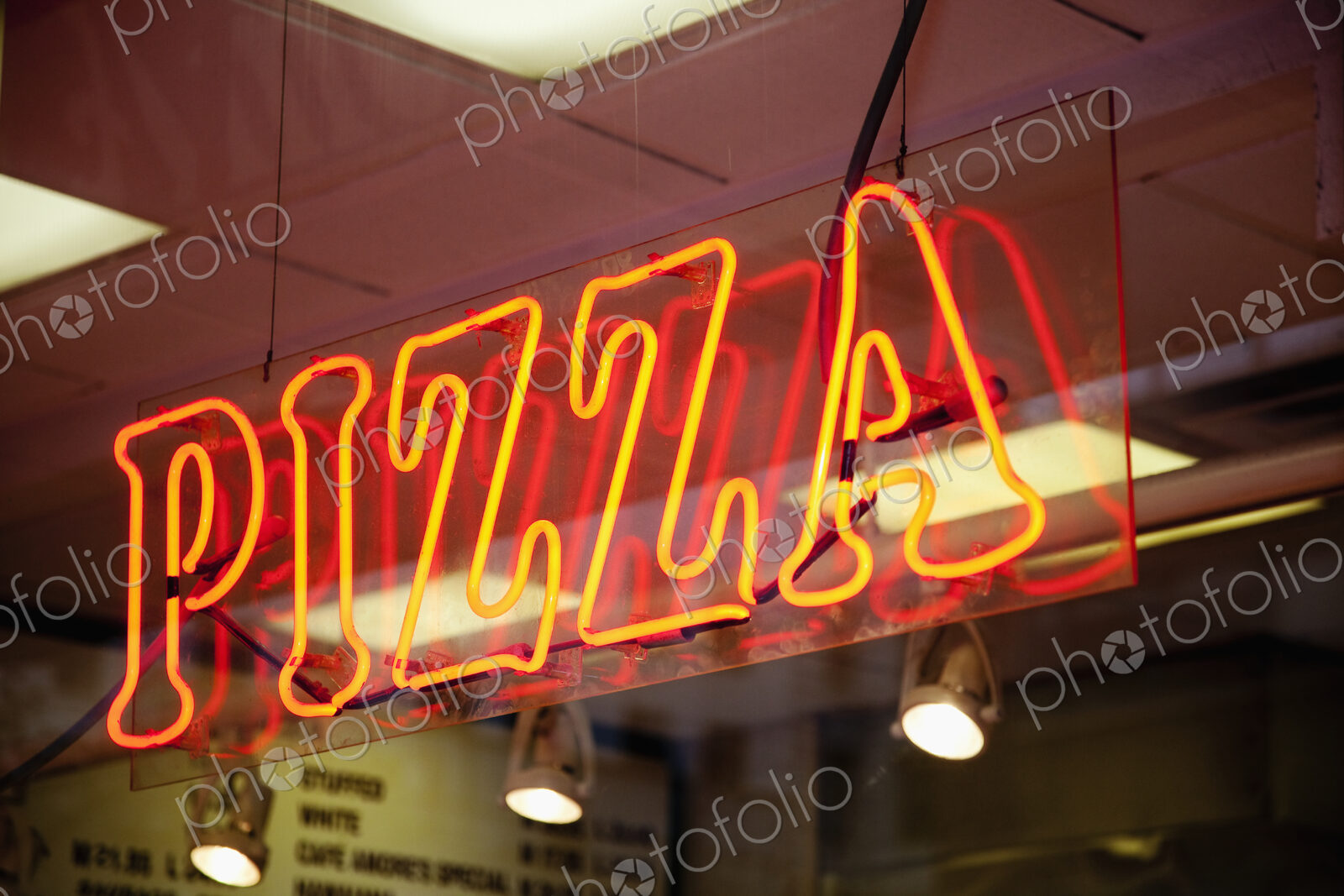 Neon Pizza Sign on Window at Night