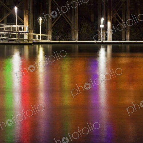 Neon lights reflect off Sacramento River water surface at night, Sacramento Neon lights reflect off Sacramento River water surface at night, Sacramento