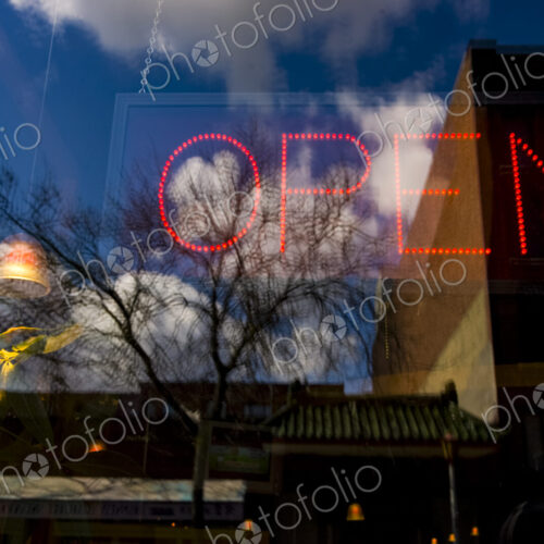 Neon open sign in window of business, Seattle, WA USA