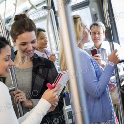 New York City park. People, men and women on a city bus. Public transport. Two women…
