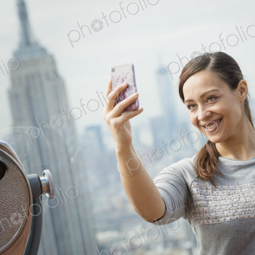 New York City. An observation deck overlooking the Empire State Building. A woman… New York City. An observation deck overlooking the Empire State Building. A woman…