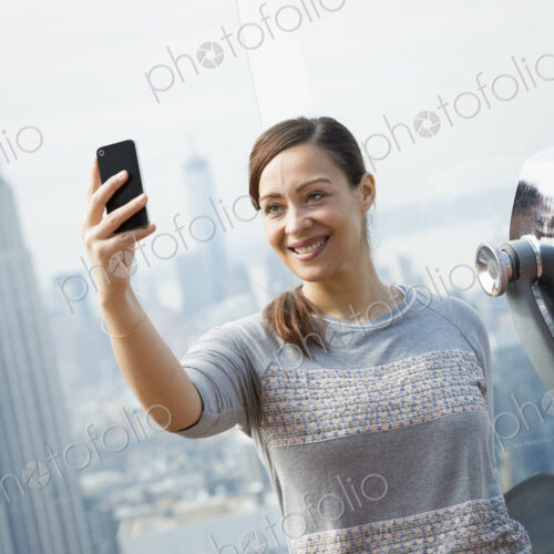 New York City. An observation deck overlooking the Empire State Building. A woman… New York City. An observation deck overlooking the Empire State Building. A woman…