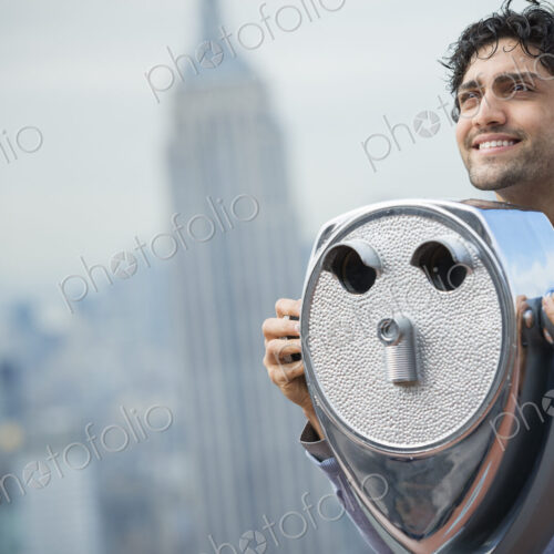 New York City. An observation deck overlooking the Empire State Building. A young man… New York City. An observation deck overlooking the Empire State Building. A young man…
