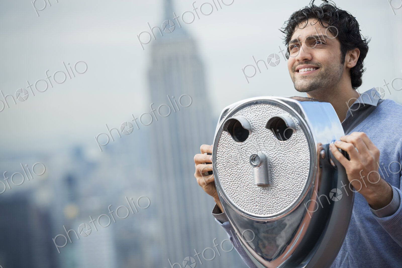 New York City. An observation deck overlooking the Empire State Building. A young man…